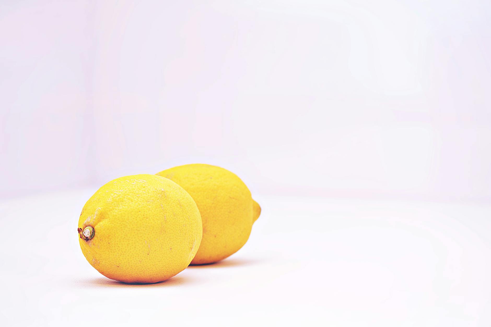 Close-up of colorful clitoral vibrators including lemon and berry-shaped adult toys arranged together
