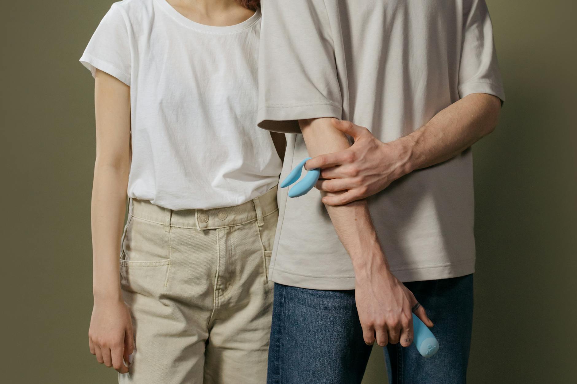 Woman holding two vibrators, representing the variety of clitoral vibrator options for first-timers.