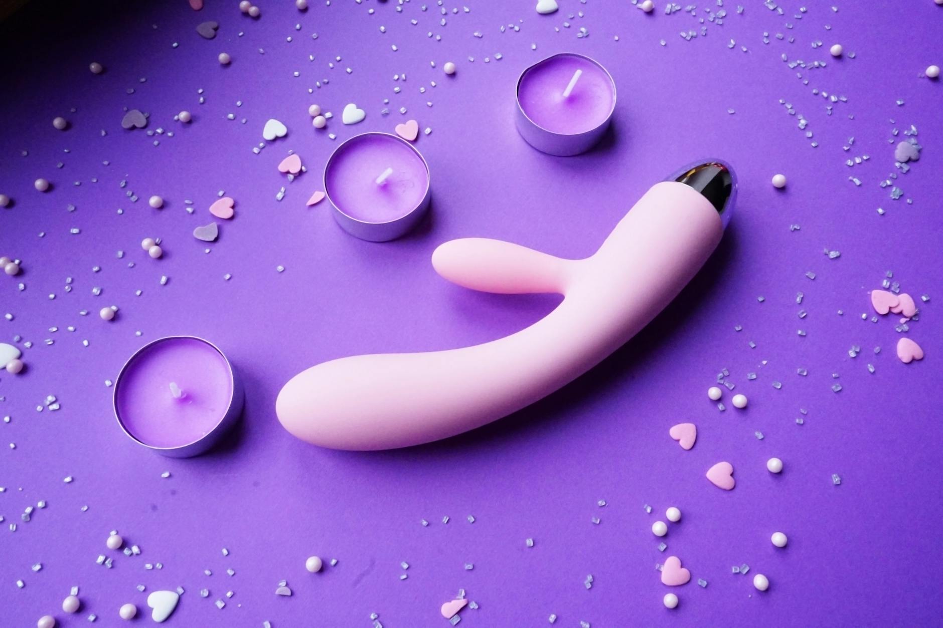 Colorful arrangement of lemon and other intimate wellness toys on a bright yellow background, showcasing diverse toy designs